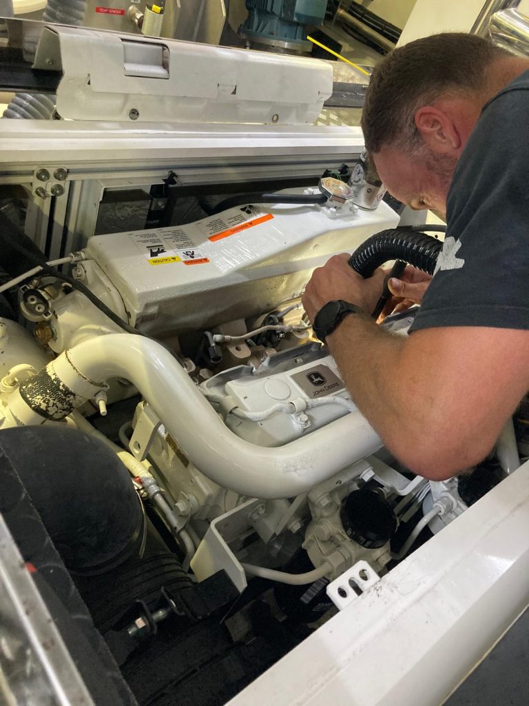 Revolution Marine Engineering Andy working on generator
